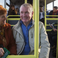 Senior,Couple,Travelling,On,The,Bus.,There,Are,Other,People