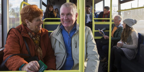 Senior,Couple,Travelling,On,The,Bus.,There,Are,Other,People