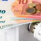 Euro,Money,Banknotes,On,Heating,Radiator,Battery,With,Thermostat,Temperature