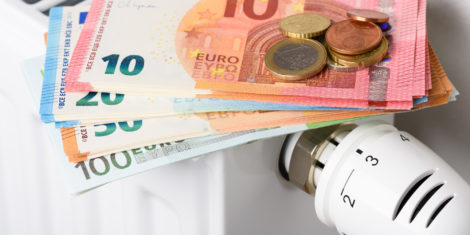 Euro,Money,Banknotes,On,Heating,Radiator,Battery,With,Thermostat,Temperature